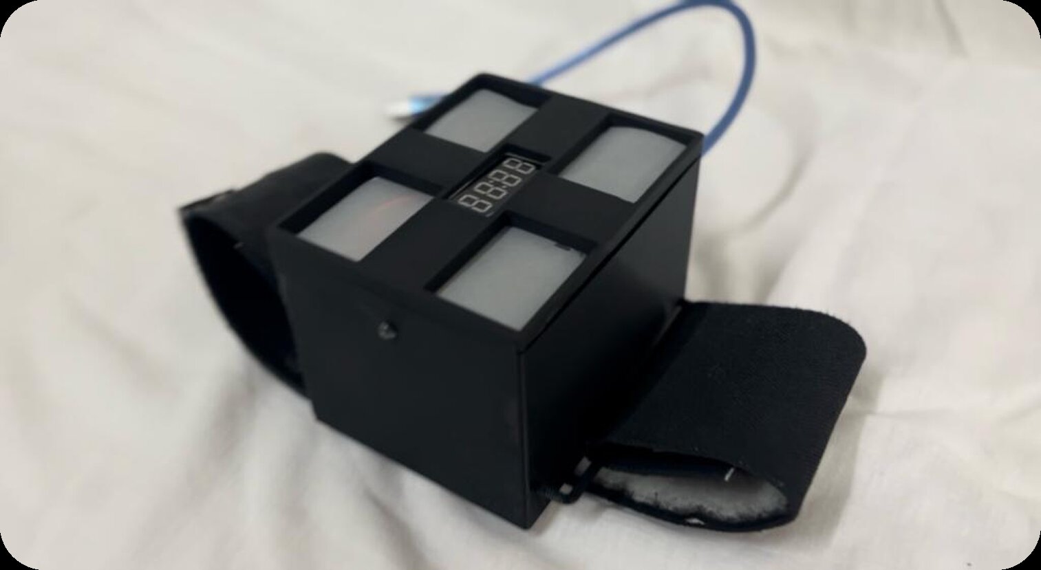 hEar prototype front close-up on wrist strap