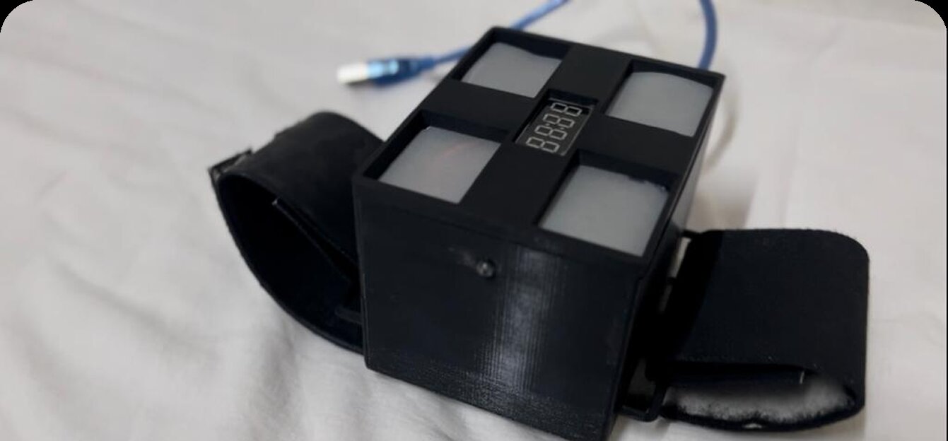 hEar prototype worn on wrist next to display watch